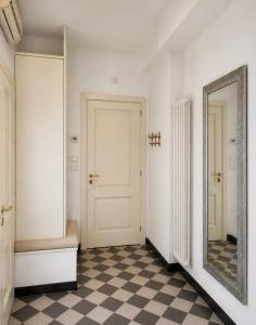 a hallway with a mirror and a checkered floor at Maison Cecilia in Rapallo