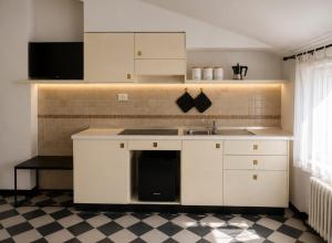 a kitchen with white cabinets and a sink at Maison Cecilia in Rapallo