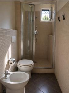 a bathroom with a shower and a toilet and a sink at Maison Cecilia in Rapallo +2 photos