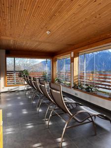 a row of chairs in a room with windows at Residenz Dunza Hotel Garni in Bürserberg