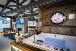 a large white bath tub in a room at Architect's Loft in Windermere