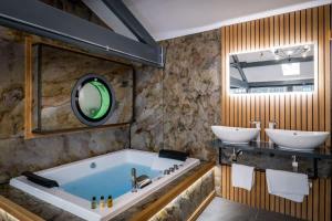 a bathroom with two sinks and a large tub at Architect's Loft in Windermere