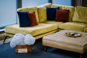 a living room with a couch and a ottoman at Architect's Loft in Windermere