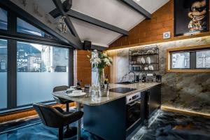 a kitchen with a counter and a table and chairs at Architect's Loft in Windermere +74 photos
