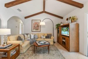 a living room with a couch and a tv at Sherylee's Poolside Retreat - Team Joseph Ellen in Jacksonville