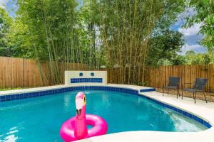 a swimming pool with a pink inflatablevisor in the water at Sherylee's Poolside Retreat - Team Joseph Ellen in Jacksonville