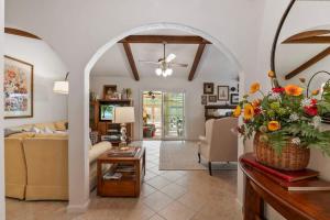 a living room with a couch and a table with flowers at Sherylee's Poolside Retreat - Team Joseph Ellen in Jacksonville