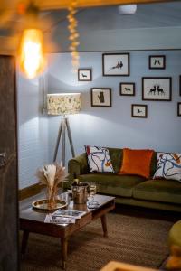 a living room with a green couch and a table at Queen's Loft in Windermere +58 photos
