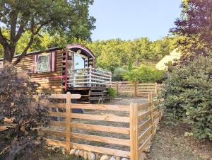 a wooden fence in front of a train at Domaine De JI in Montagnac