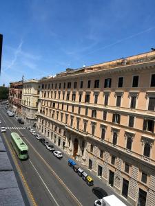 a large building with cars parked next to a street at Ciao Termini in Rome
