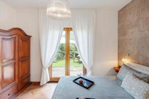 a bedroom with a bed and a large window at Villevieille in Piano di Sorrento