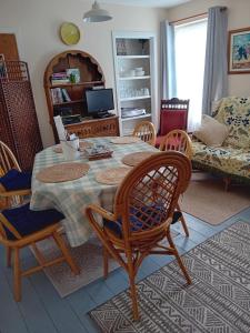 a living room with a table and chairs at Owls Roost in Stowmarket