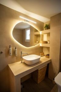 a bathroom with a sink and a mirror at Cerro Fine Living in Ermoupoli +18 photos