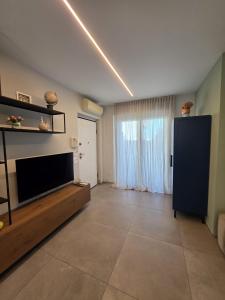 a large living room with a flat screen tv at Casa Alma in Lido di Fermo