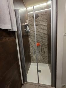 a shower with a glass door in a bathroom at Casa Alma in Lido di Fermo