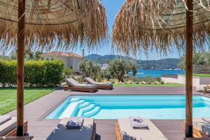 a villa with a swimming pool and a resort at Marani Villas Collection in Skopelos Town