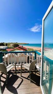 a balcony with chairs and a view of the beach at Hanlon Guest House in Stanley
