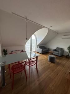 a living room with a table and two chairs at SWISS LOFT by Europa-Park - EP Ticket Garantie in Rust