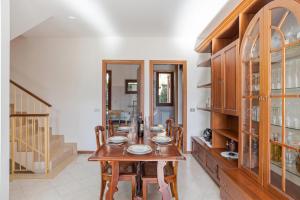 a dining room with a wooden table and chairs at Lenno Glamour in Lenno