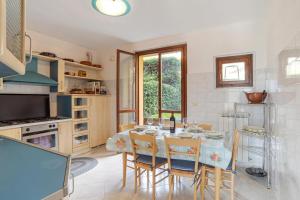 a dining room with a table and chairs and a kitchen at Lenno Glamour in Lenno