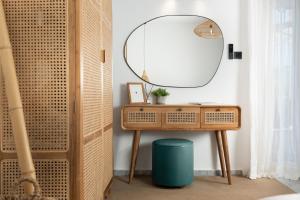 a dressing table with a mirror and a stool at Studio Apartment 5, Unique Location - Sea View in Lithakia