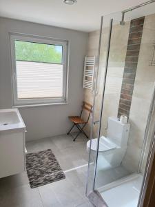 a bathroom with a shower and a toilet and a window at Pokoje przy rzece in Supraśl +18 photos