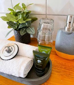 a tray with a towel and a bottle of moisturizers and a candle at Hanlon Guest House in Stanley