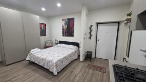 a bedroom with a bed with a comforter on it at B&B Lamezia Terme Centro in Lamezia Terme