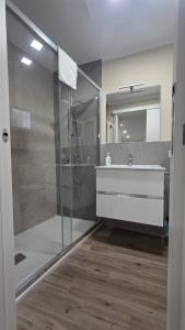 a bathroom with a glass shower and a sink at B&B Lamezia Terme Centro in Lamezia Terme