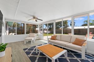 a living room with a couch and a table at Teal We Meet Again - Team Joseph Ellen in Jacksonville Beach