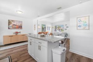 a kitchen with white cabinets and a counter top at Teal We Meet Again - Team Joseph Ellen in Jacksonville Beach +75 photos