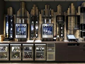a display of wine bottles on a counter in a store at Mercure Amsterdam City Hotel in Amsterdam
