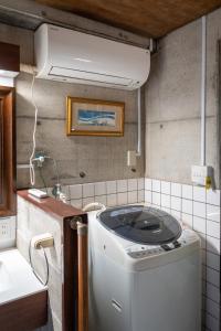 a washer and dryer in a kitchen with a ceiling at Penthouse KOKO in Miyakonojō +38 photos