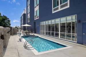 a swimming pool in front of a building at SpringHill Suites by Marriott Atlanta Covington in Covington