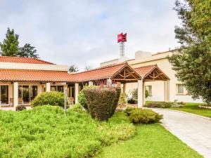 a building with a red cross on top of it at Hotel ibis Setubal in Setúbal