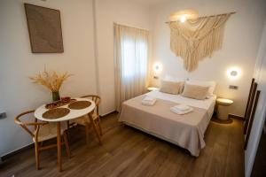 a small room with a bed and a table at Cerro Fine Living in Ermoupoli