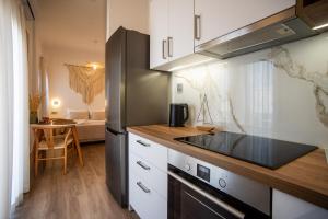 a kitchen with a refrigerator and a table in a room at Cerro Fine Living in Ermoupoli