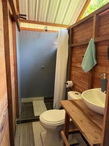 a bathroom with a toilet and a sink at Pal Mar in Nuquí +41 photos