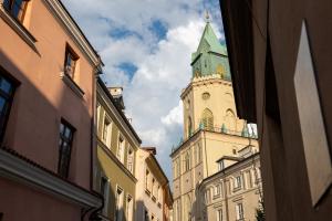 a tall building with a clock tower in a city at Lublin Old Town Studio by BookingHost in Lublin