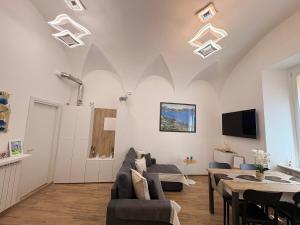 a living room with a couch and a table at Home Albert-Lago Maggiore Luino in Luino