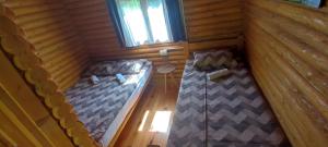 an overhead view of two beds in a log cabin at Kamp Bato in Brijeg