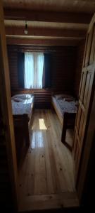 a small room with two beds and a window at Kamp Bato in Brijeg