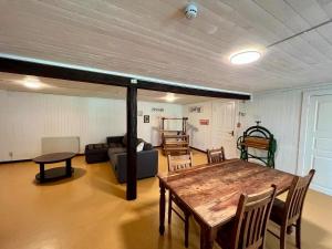 a living room with a table and a couch at Ferienwohnung Runeholm in Fjälster +4 photos