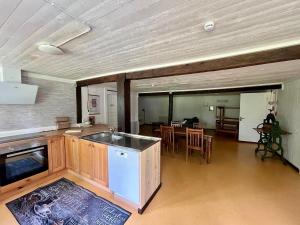 a kitchen and dining room with a table and chairs at Ferienwohnung Runeholm in Fjälster