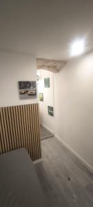 a room with white walls and a wooden floor at Studio Istres in Istres