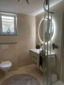 a bathroom with a shower and a toilet and a sink at Mng home in Kippenheim +6 photos