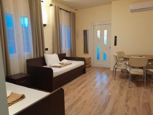 a living room with a bed and a dining room at Leni in Ierissos