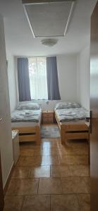 a room with two beds and a window at Penzion Bernardýn in Bořetice