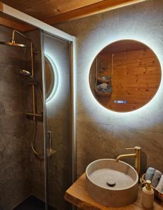 a bathroom with a sink and a shower with a mirror at Chalet Bergliebe Turrach in Turracher Hohe