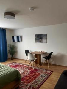 a bedroom with a bed and a table and chairs at Mocafe Schloßbleiche in Wuppertal